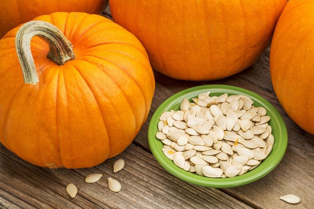 Pumpkins and seeds on a wooden table