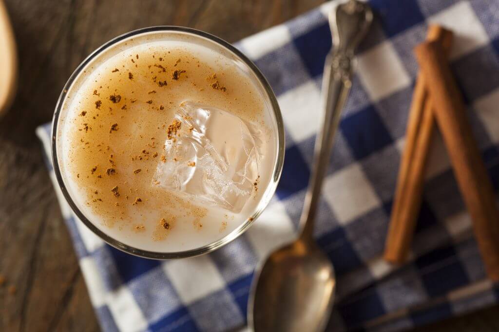 Iced horchata with cinnamon on checkered napkin