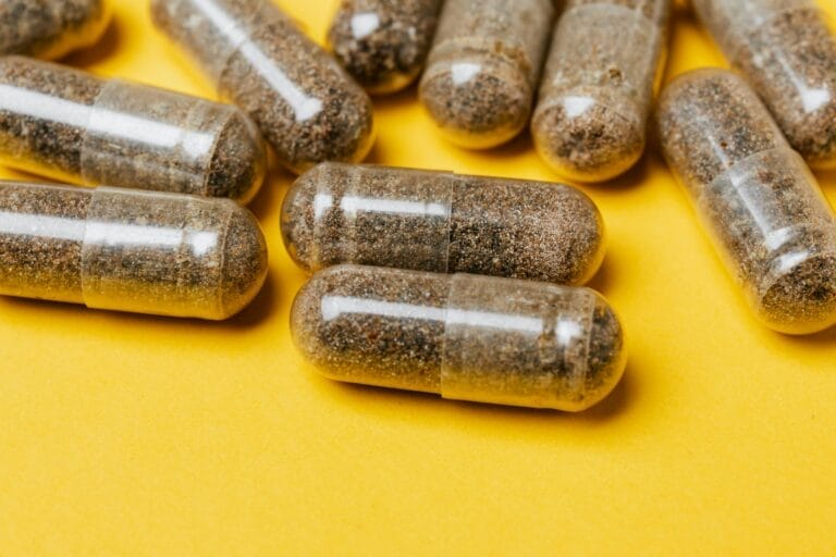 Close-up of clear capsules on a vibrant yellow surface, offering potential for health-related content