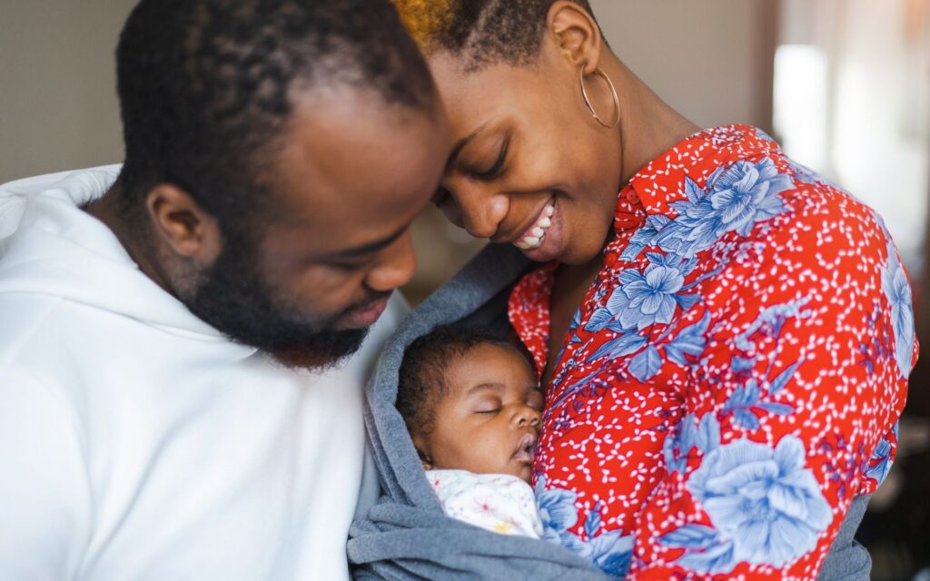Couple snuggles their newborn baby. Placenta encapsulation in Shertz, TX
